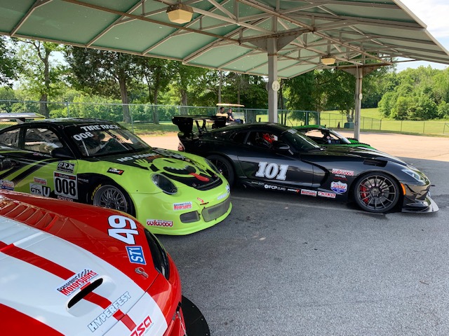 Reg's Porsche is in the middle of a Viper sandwich! 